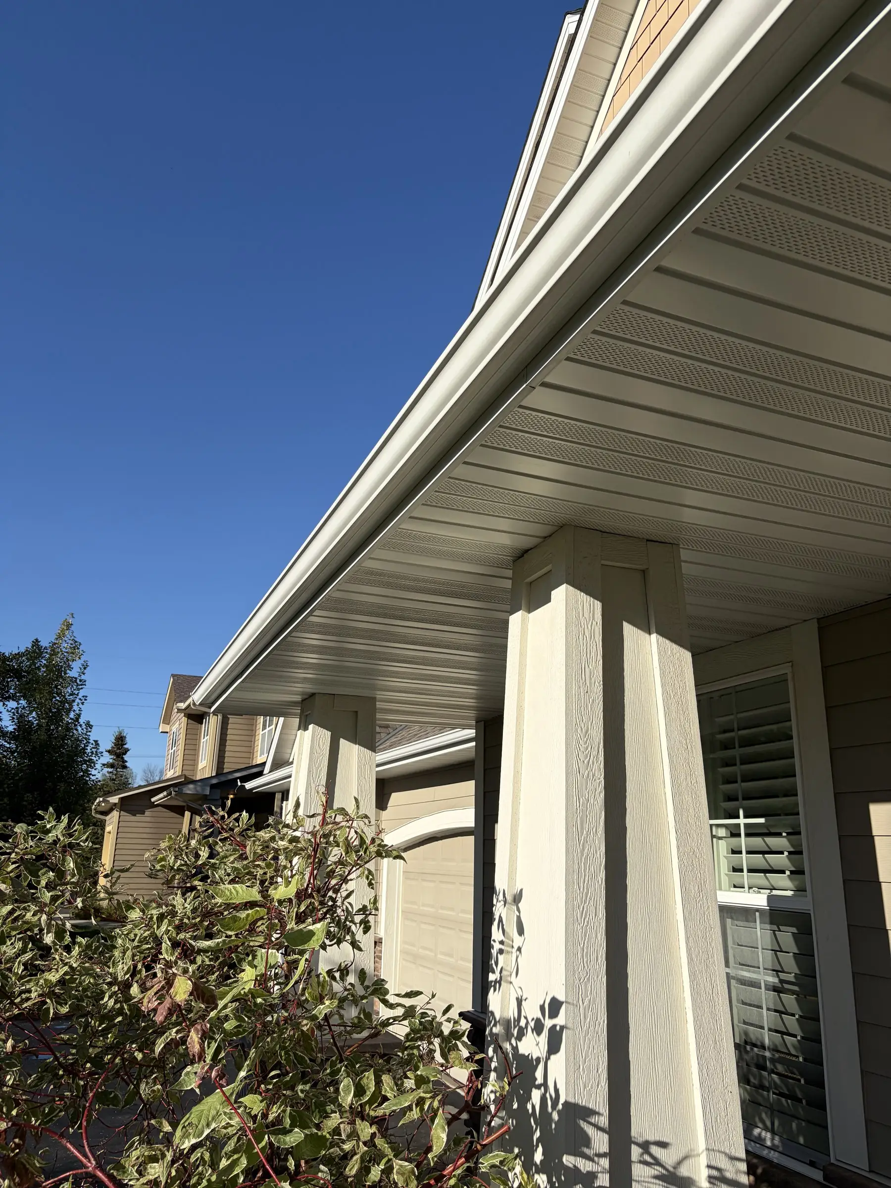 After: the same gutter and soffit, bright white