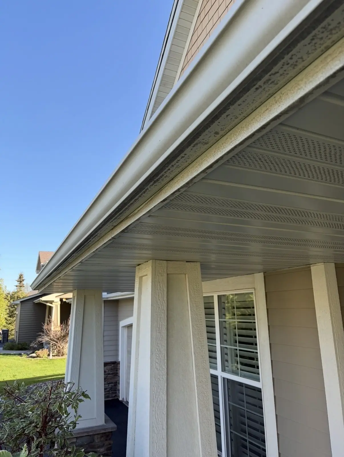 Before: white gutter and soffit with dark streaks