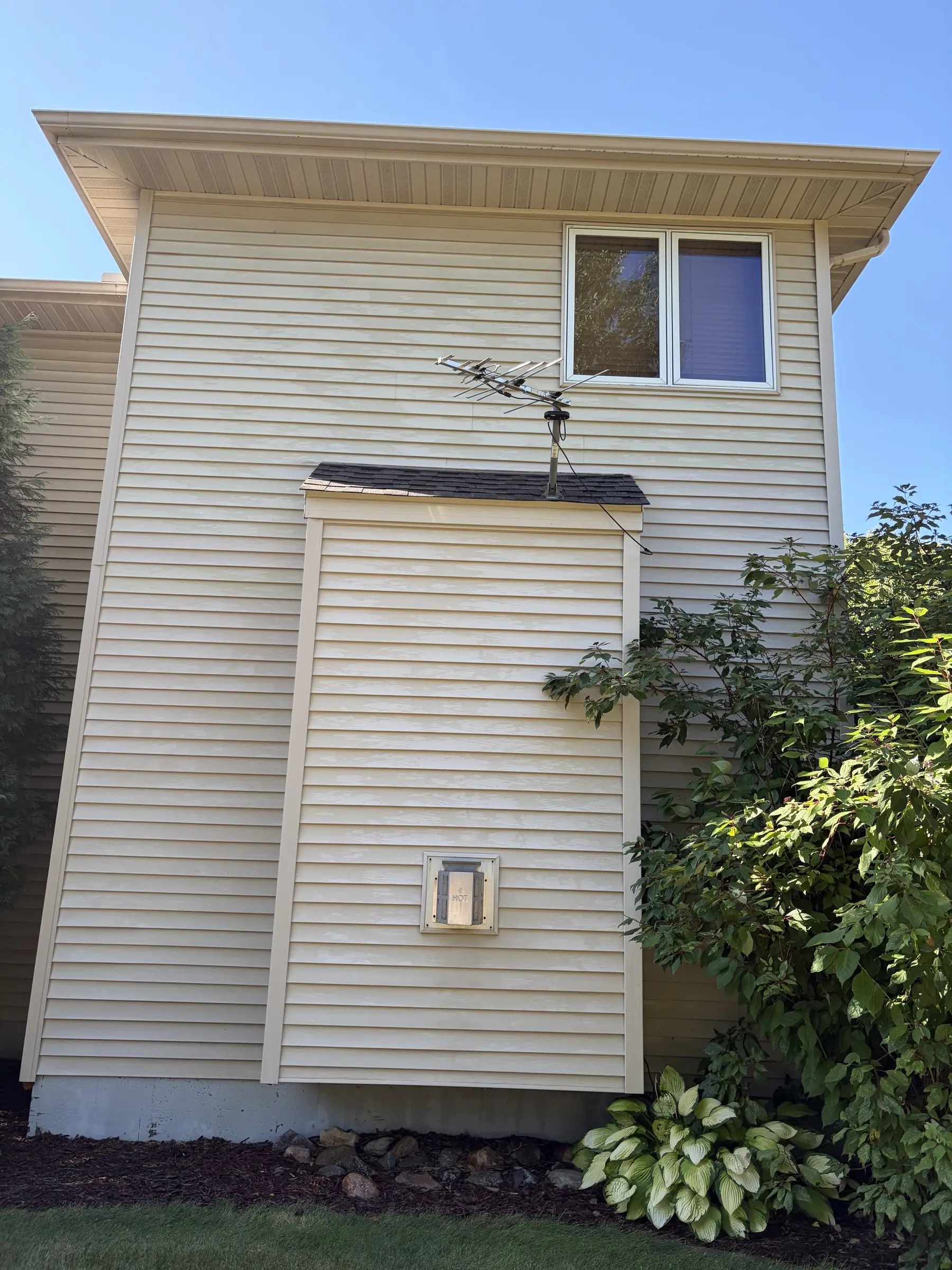 After: the same siding, clean and even in color