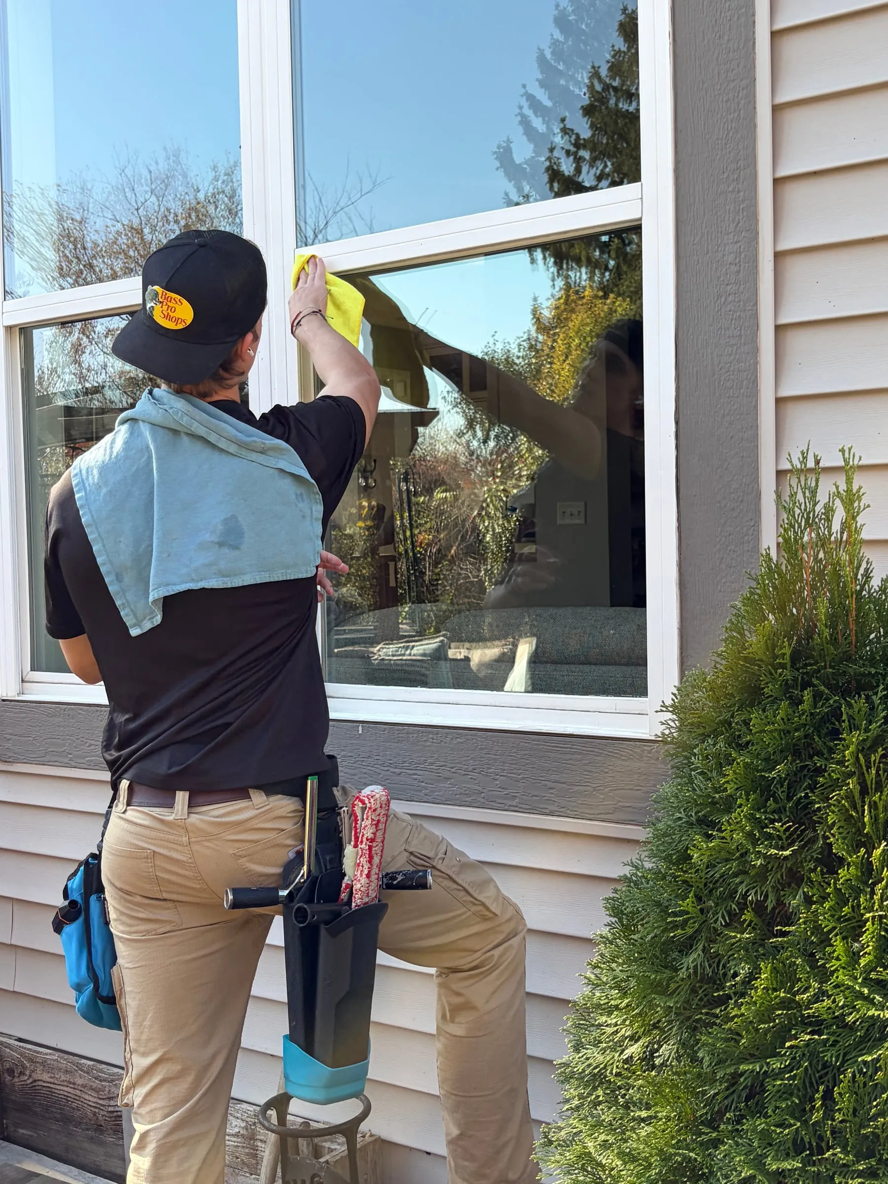 Sam detailing a window frame with a cloth