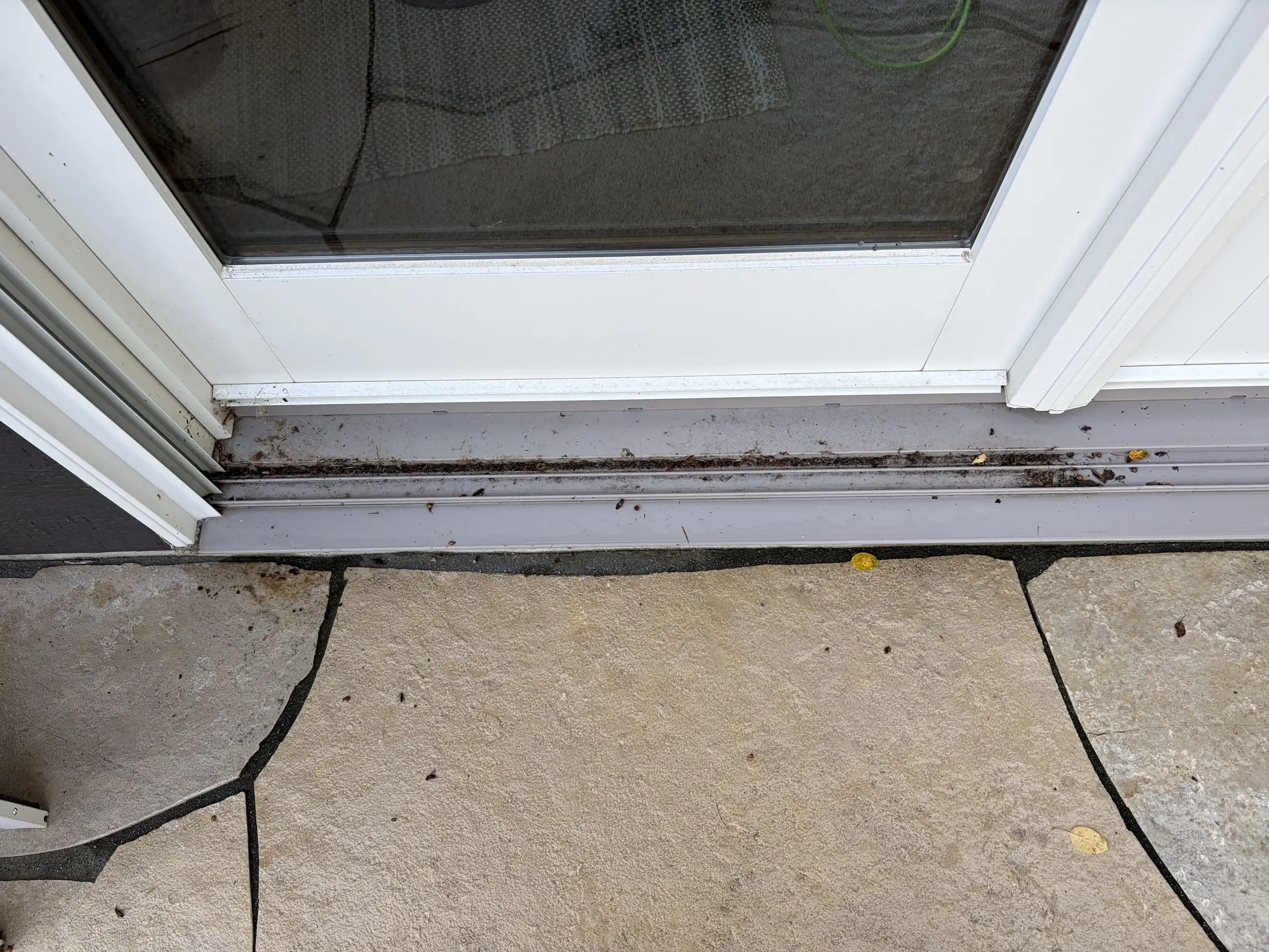 Before: a patio door track with dirt and debris